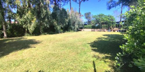 a large field of grass with trees in the background at Solea Village sul mare in San Sostene Marina