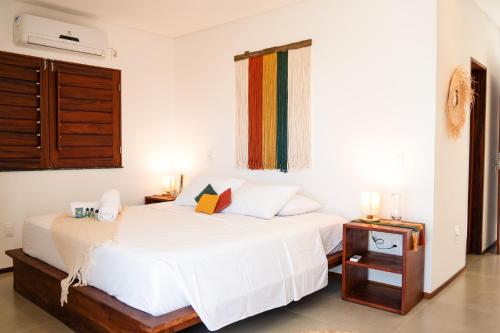 a bedroom with a white bed and a window at @Casa.Mauii - Ilha do Guajiru Luxurious House in Itarema