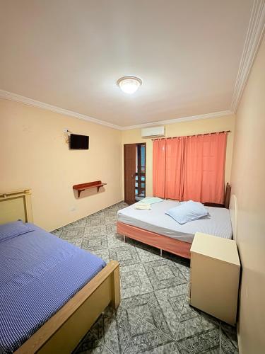 Ένα ή περισσότερα κρεβάτια σε δωμάτιο στο Pousada Beiramar