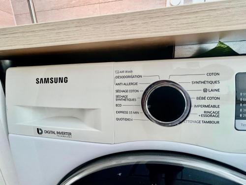 a washer and dryer sitting on top of a washing machine at Golfe de Saint Tropez, 5min beach, 1 chambre , 1 canapé lit , terrasse in Gassin