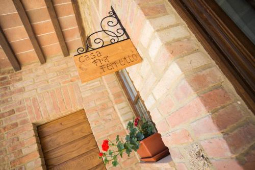 a sign on the side of a building with a plant at Casale San Galgano in Chiusdino