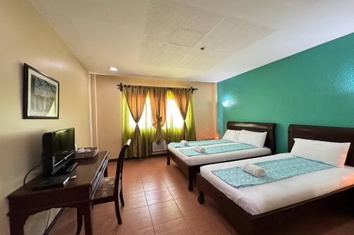 Postel nebo postele na pokoji v ubytování OveMar Resort Hotel near Vigan