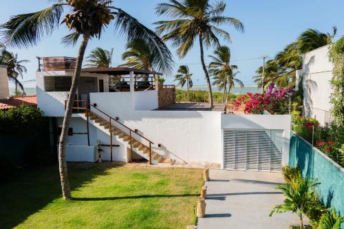 a view of a house with a palm tree at @Casa.Mauii - Ilha do Guajiru Luxurious House in Itarema