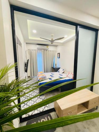 a room with a bed and a mirror at Hostique Blossom, Private Studio for Staycation in Indore