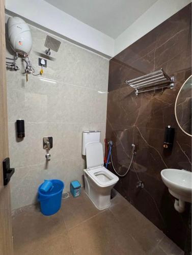 a bathroom with a toilet and a sink at Hostique Blossom, Private Studio for Staycation in Indore