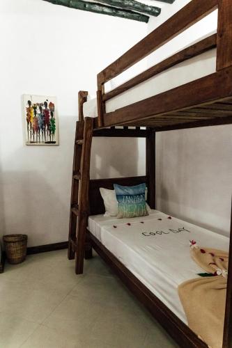 a bedroom with two bunk beds in a room at Shoki Shoki Guest House in Zanzibar City