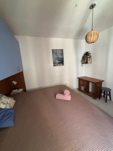 a bedroom with a bed with a pink blanket on it at arzella flat in St Paul's Bay