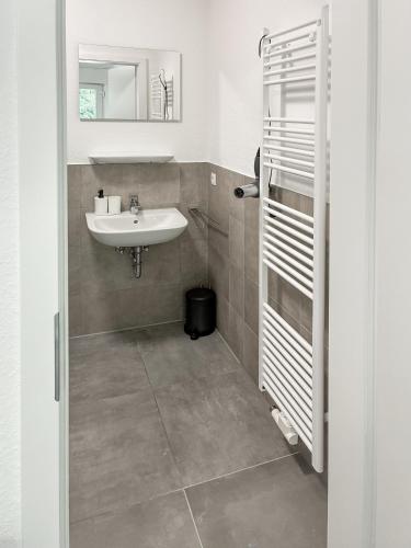 a bathroom with a sink and a mirror at Sportpark Reken Apartment III in Reken