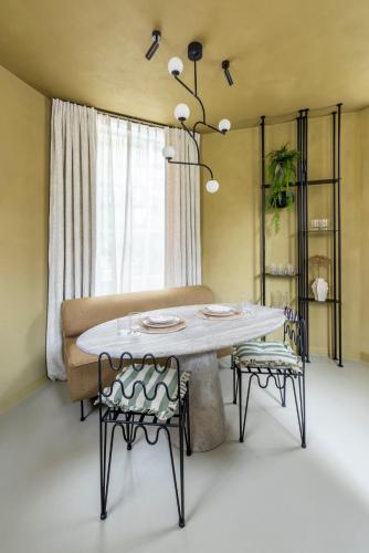 a dining room table with two chairs and a couch at Lotz - one-of-a-kind boutique center suite in Amsterdam