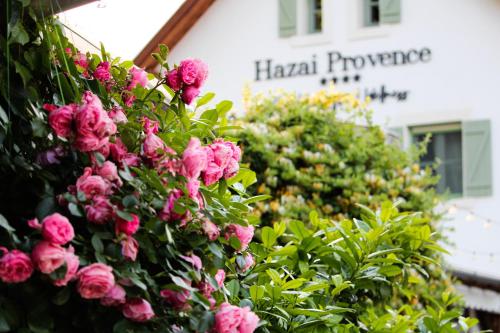 a bunch of pink flowers in front of a building at Hazai Provence in Kapolcs
