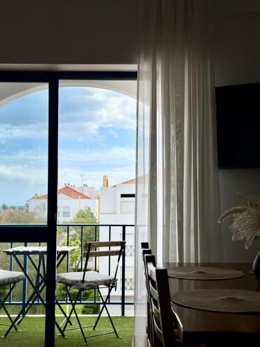a room with a balcony with a table and chairs at Apartment in Altura, Algarve with Balcony Near Beach and Town Center in Altura