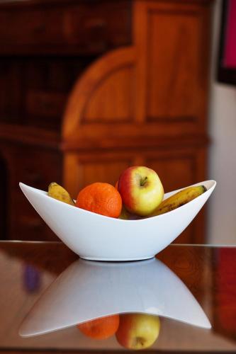 a white bowl of fruit on a table at Boutique Hotel El Tio Kiko in Agua Amarga