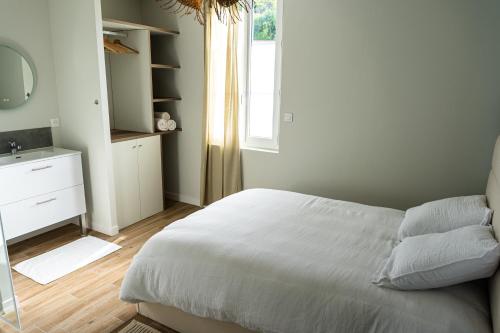 une chambre avec un lit, un lavabo et un miroir dans l'établissement Appartement cosy tout confort et calme en Ardéche,parking privé, à Le Teil