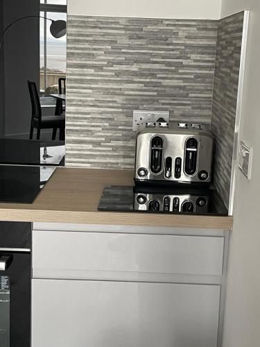 a toaster sitting on top of a kitchen counter at Sunbeam House 2 Morecambe Accessible in Morecambe