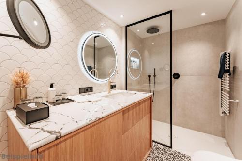 a bathroom with a sink and a shower at Strandhotel Kurhaus Juist in Juist