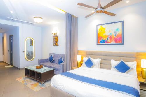a hotel room with a bed and a chair at Hotel Livbox at Supernova in Noida