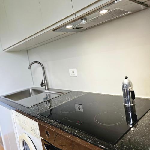 a kitchen with a sink and a counter top at Kuqa Rent House in Ksamil