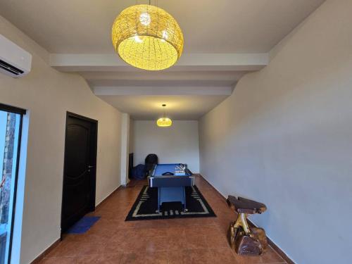 a room with a table and a light fixture at Posada-Hotel El Remanso in Itá