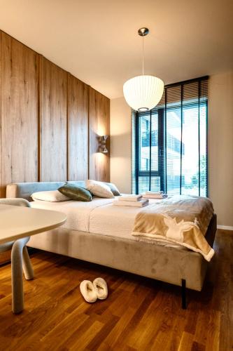 a bedroom with a large bed and a table at Nook in Timişoara