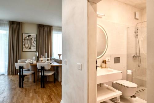 a bathroom with a sink and a toilet and a table at Nook in Timişoara