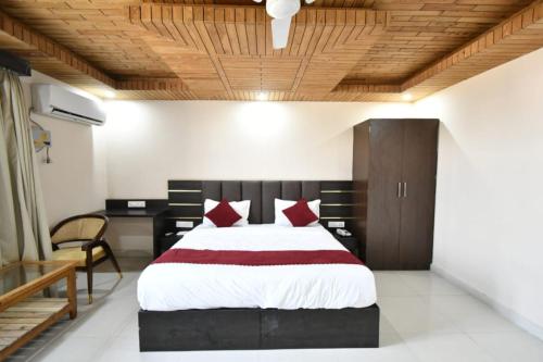 a bedroom with a large bed and a wooden ceiling at Hotel Ram Janaki Palace in Tikri Kalān