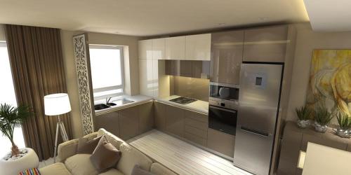 a living room with a couch and a kitchen at TAN GoLD in Constanţa
