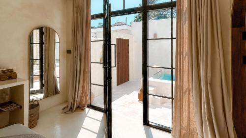 an open door to a room with windows at Cahaya Villas - Luxury Villa With Private Pool in Gili Trawangan