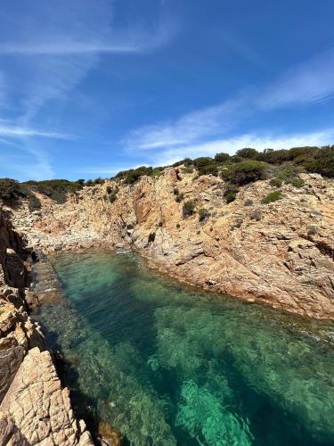an aerial view of a body of water on a rocky shore at Villa CHIA in Chia