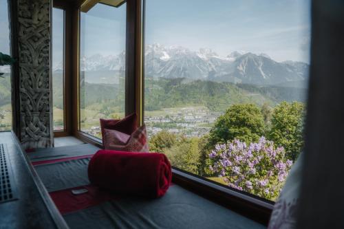 a room with a large window with a view of mountains at Pension Spreitzhof & Appartement Royer in Schladming