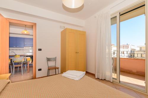 a living room with a bed and a dining room at Le Tartarughe Aparthotel in Letojanni