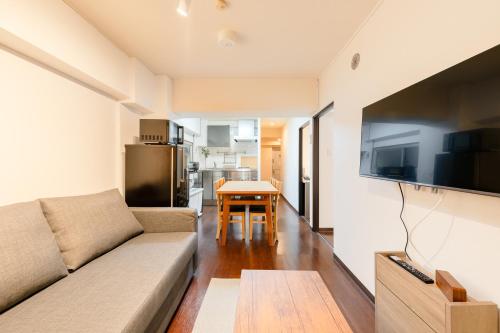 a living room with a couch and a table at ホテル富士見マンション in Tokyo