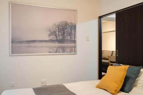 a bedroom with a large picture on the wall at ホテル富士見マンション in Tokyo