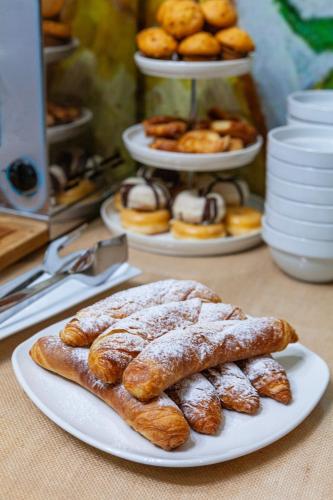 a table with three plates of pastries on a table at Olympia Consul del Mar in Valencia