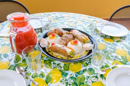 a table with a plate of food on a table at Le Tartarughe Aparthotel in Letojanni