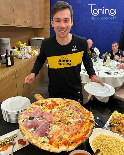 a man standing in front of a large pizza at Hotel Ristorante Da Tonino in Recanati