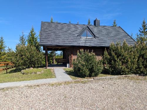 a house with a gambrel roof with a porch at Trevena Endriejavas in Endriejavas
