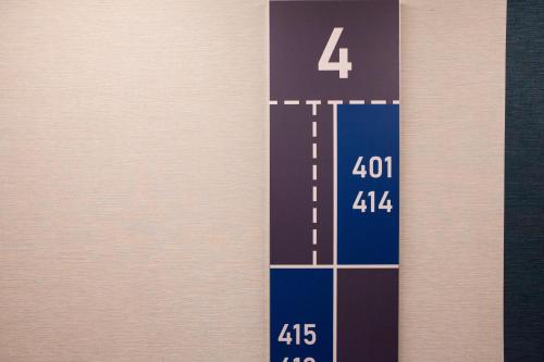 a blue and white stripe with a number four at ibis budget Hotel Berlin Airport in Berlin