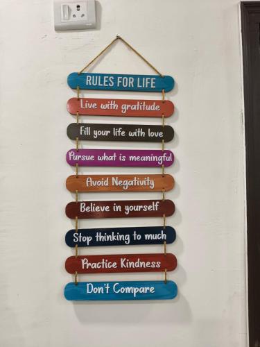 a sign that reads rules for life live with gratitudefull your life with loveurance at 2 BHK Dreamy Nest With Private Pool in Greater Noida