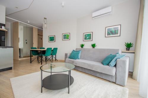 a living room with a couch and a table at InPoint Central Apartments in Kraków