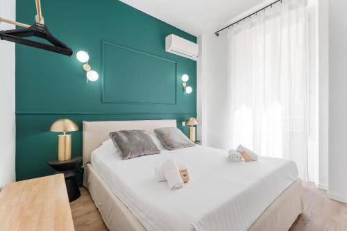 une chambre avec un lit blanc avec un mur bleu dans l'établissement Appartement Caire - Welkeys, à Cannes