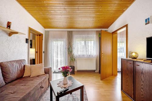 a living room with a couch and a table at Ferienwohnung Horn in Kaiserslautern