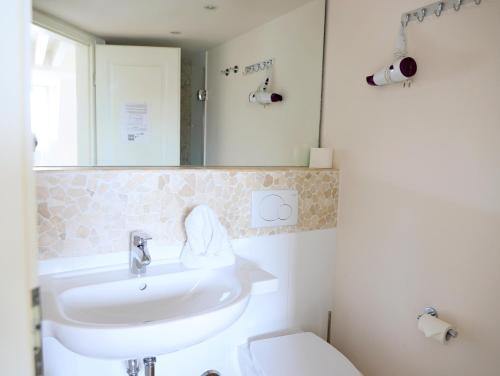 a bathroom with a sink and a toilet at Hafenstraße 4, Whg. 4 in List