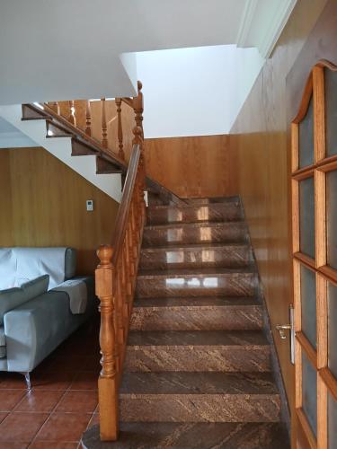 a staircase leading up to a living room with a couch at Casa Pucho in Barreiros