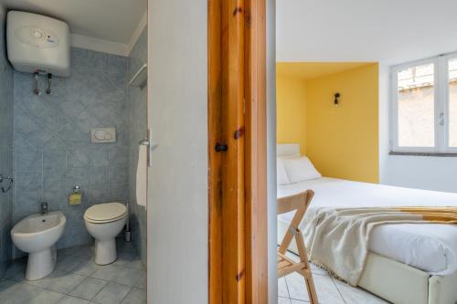 a bathroom with a bed and a toilet and a sink at Panieri Apt - Homkeey Apartments in Rome