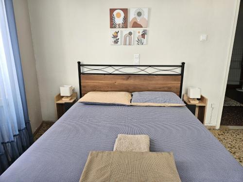 a bed in a bedroom with two night stands at Cozy Stone House in Central Zacharo - Near Beach in Zakharo