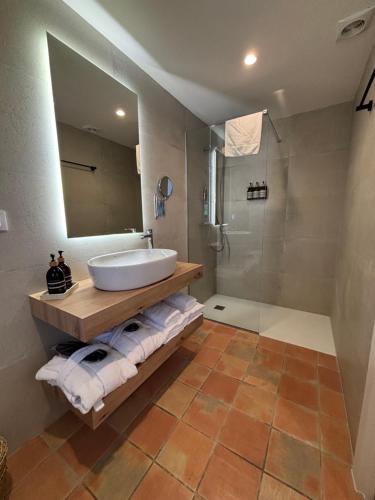 a bathroom with a sink and a shower at Hotel Convent de Begur in Begur