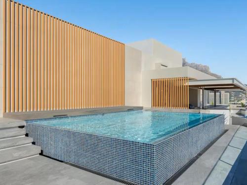 a swimming pool in the middle of a house at The Rubik: Luxury secure apartment in Cape Town in Cape Town