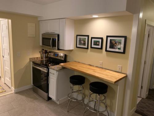 a kitchen with a counter and two bar stools at Cottage11 of Avalon -2 Bedroom-1 Bath- Laundry- Sleeps 6 in Lansing