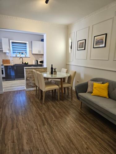 a living room with a table and a couch at Apartmani M&L in Medulin