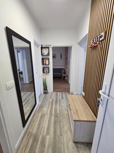 a hallway with a mirror and a stair case at Apartmani M&L in Medulin